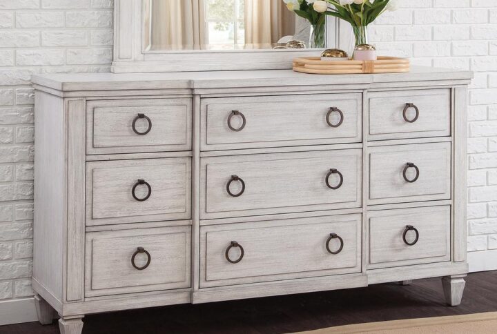 The Salter Path 9-Drawer Dresser is a casual classic with modern touches and designer details.  The White Oyster wire-brushed finish with flecks of gray offers a natural textured look.  Antiqued silver ring pulls and square tapered feet add flair to this beautiful dresser.  Also features roller-bearing side glides for easy drawer operation and English dovetail for durability.