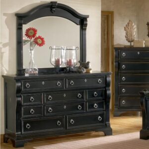 An heirloom is a timeless treasure that passes from generation to generation bringing each family member immeasurable joy through memories. The Heirloom Triple Dresser is a masterful piece of tradition that is finished in a distressed black finish with hints of gold rubbed through. From the heavy top to the beaded drawer fronts this dresser was made to love for generations. The pewter ring pulls are brushed for a traditional look and feel. The drawers are center guided with positive drawer stops for years of smooth quiet function. And the 14 ½" drawers have English dovetail construction and fully finished interiors for a lifetime of snag free use. Enjoy a tradition of creating ageless family heirlooms with the Heirloom Triple Dresser.