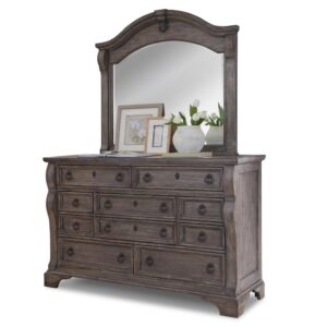 An heirloom is a timeless treasure that passes from generation to generation bringing each family member immeasurable joy through memories. The Heirloom Triple Dresser is a masterful piece of tradition that is finished in a rustic charcoal finish with rub through. From the heavy top to the beaded drawer fronts this dresser was made to love for generations. The pewter ring pulls are brushed for a traditional look and feel. The drawers feature roller bearing side glides with positive drawer stops for years of smooth quiet function. And the 14 ½" drawers have English dovetail construction and fully finished interiors for a lifetime of snag free use. The decorative arched crown rail is reminiscent of late 17th century architecture. Its centered medallion shape decoration and curved case nostalgically frames the reflective