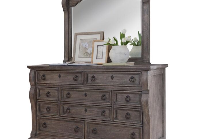 An heirloom is a timeless treasure that passes from generation to generation bringing each family member immeasurable joy through memories. The Heirloom Triple Dresser is a masterful piece of tradition that is finished in a rustic charcoal finish with rub through. From the heavy top to the beaded drawer fronts this dresser was made to love for generations. The pewter ring pulls are brushed for a traditional look and feel. The drawers feature roller bearing side glides with positive drawer stops for years of smooth quiet function. And the 14 ½" drawers have English dovetail construction and fully finished interiors for a lifetime of snag free use. The decorative arched crown rail is reminiscent of late 17th century architecture. Its centered medallion shape decoration and curved case nostalgically frames the reflective