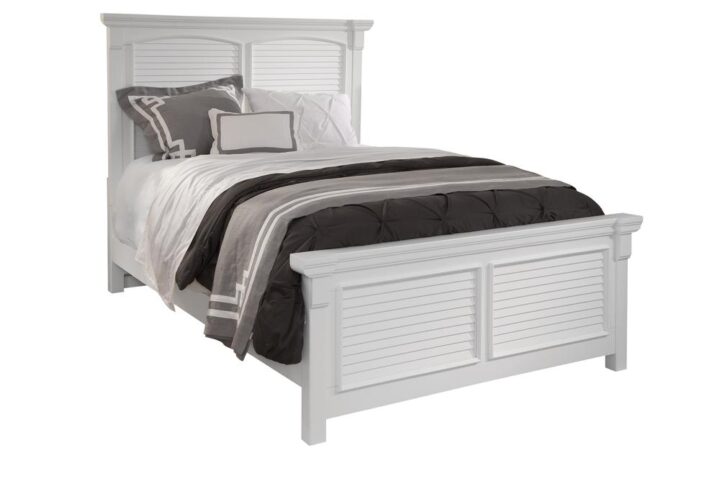 Bring instant charm and warmth to your bedroom with Cottage Traditions Square King Panel Bed from American Woodcrafters. The eggshell white finish and the vintage breakfront look formed by the coped crown blocks on both the headboard’s and the footboard’s straight cap rail lends to the handcrafted look. Wide molding houses the decorative louvered inserts on both the headboard and footboard and ties the pieces of this collection together.  Wide vertical posts add weight to both headboard and footboard.  Mortise and tenon construction give this furniture strength and durability as well as charm.