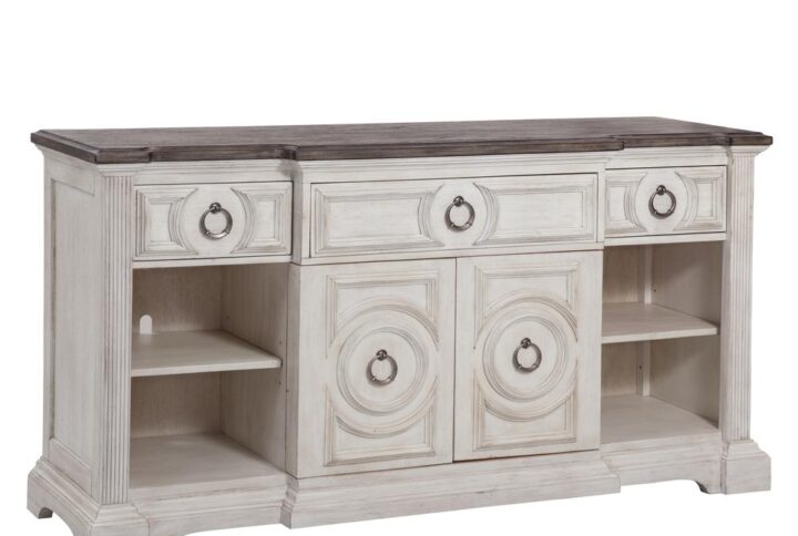 Experience southern charm with a modern twist when you choose the Brighten 72" Console.  The heavily distressed antique white finish is complemented by the antique charcoal tops and modern pewter ring drawer and door pulls.  Architectural pilasters frame the pieces and enhance the transitional circular designs and raised moldings of the drawer fronts.  This entertainment console features 3 drawers for storage and cabinets with a unique pivot hinge design that allows you to pivot the two cabinet doors from the middle to the ends.  The cabinets each include one adjustable shelf with grommets in the back panel for wire and cord management.  A beautiful