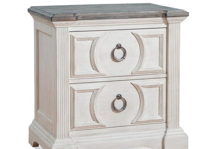 Experience southern charm with a modern twist in the Brighten Bedroom Collection.  The heavily distressed antique white finish is complemented by the antique charcoal tops and modern pewter ring drawer pulls.  Architectural pilasters frame the pieces and enhance the transitional circular designs and raised moldings of the drawer fronts.  The Brighten Nightstand features 2 drawers for bedside storage with felt lining in the top drawer to protect your finer things.  Your purchase includes one nightstand.