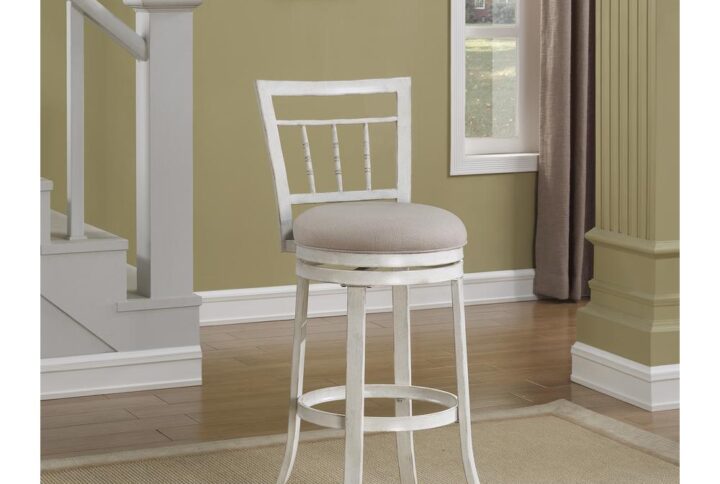 Enjoy the urban cottage style of the Palazzo bar stool.  This metal stool is finished in a hand painted antique white finish. The decorative slat back and beige fabric seat will complement a variety of decors.  The full 360° swivel is complemented by the circular footrest that will keep you comfy no matter which way you turn.