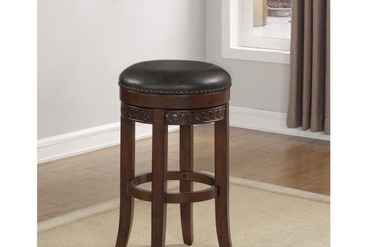 Let the Conrad Backless Counter Stool bring the ultimate in traditional design and comfort to your home.  Constructed with a solid hardwood frame in a warm cherry finish with a sturdy footrail for durability.  The 360° swivel seat features a 3" thick bonded leather cushion in a deep french roast accented by antique brass nail head trim and a decorative carved seat ring.   The perfect seating choice for your family and guests.