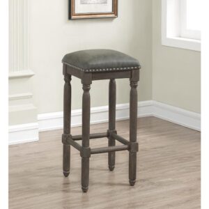 The vintage feel of the Bronson Backless Bar Stool is highlighted by the wire brushed driftwood finish and nail head accents.  Features include sturdy solid hardwood construction