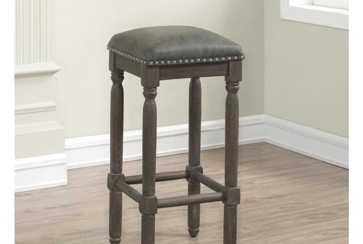The vintage feel of the Bronson Backless Bar Stool is highlighted by the wire brushed driftwood finish and nail head accents.  Features include sturdy solid hardwood construction