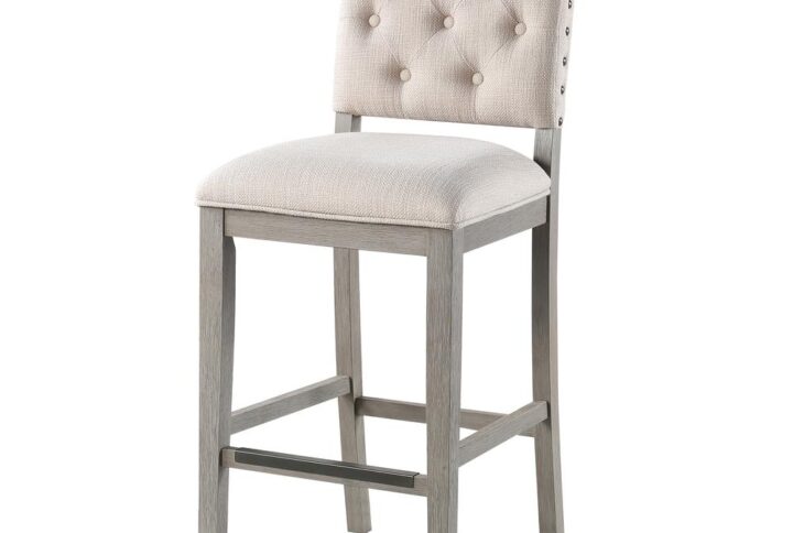 Comfort awaits with the stylish Ellesse Bar Height Stool with a solid hardwood frame finished in a weathered gray with easy to care for cream polyester fabric upholstery on the seat and back.   Stylish welted seams