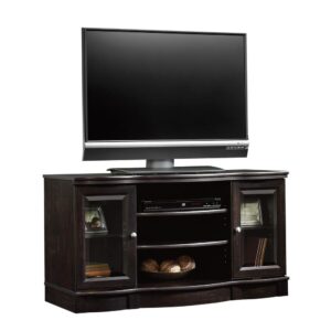 Create a warm and inviting living room or entertainment space with this charming TV stand from the Sauder Select collection. This handsome stand accommodates up to a 50" TV