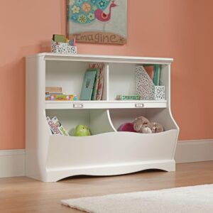 blankets and their favorite toys in the cubbyhole storage spaces of this white bookcase. The storage bins offer a convenient place for board games