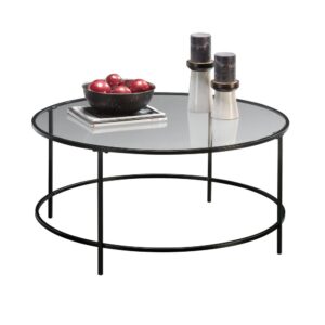 Giving your home a sophisticated new look has never been easier. Create a one-of-a-kind aesthetic in your home with the simplistic design and charming good looks of this round coffee table from the Harvey Park® collection. This stunning coffee table features a uniquely designed round surface with a safety-tempered glass top that is sure to stand out. Its spacious top surface provides you with all the room you need for all your couch side necessities like a place to set the TV remote