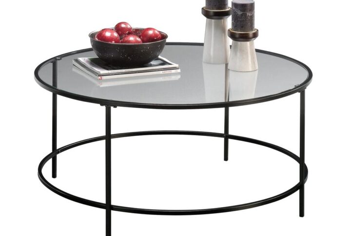 Giving your home a sophisticated new look has never been easier. Create a one-of-a-kind aesthetic in your home with the simplistic design and charming good looks of this round coffee table from the Harvey Park® collection. This stunning coffee table features a uniquely designed round surface with a safety-tempered glass top that is sure to stand out. Its spacious top surface provides you with all the room you need for all your couch side necessities like a place to set the TV remote