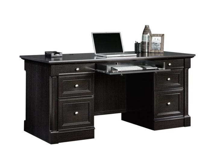 Beautify your home office or workspace with the charming style and simplistic design of this executive desk from the Palladia® collection. This executive office desk features a spacious desk top surface that provides ample room for all your must-have desk essentials ranging from your laptop and cup of coffee to your collection of notepads and an accent lamp. This home office desk features a large drawer/shelf with a flip-down panel for your keyboard/mouse or laptop. Four smaller drawers that open and close on smooth metal runners allow for easy access storage of miscellaneous office supplies like pens