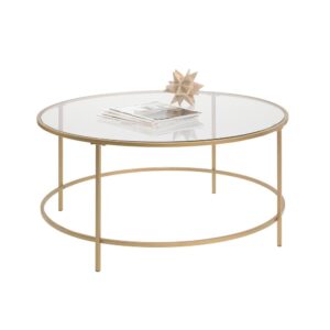 Sophisticated and cool. This round coffee table from the International Lux® collection can add a touch of luxury to any room. This gold rimmed table features a safety-tempered glass top for a chic look that looks great as a centerpiece of any room. The metal construction of this round modern coffee table is designed for long lasting durability. Finished on all sides for versatile placement in any room of your home