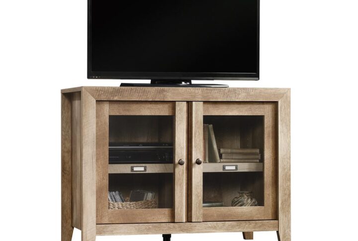 Take a pass on the ordinary. The perfect sideboard / storage cabinet for showcasing items on top while displaying more behind glass doors inside the cabinet. Make a bold statement with this display cabinet from the Dakota Pass® collection. Finished in traditional rustic country Craftsman Oak® and detailed with a contemporary sensibility. This functional storage credenza includes an adjustable shelf and can hold up to a 42" TV on top. Get inspired with this perfect solution for any room of the home.