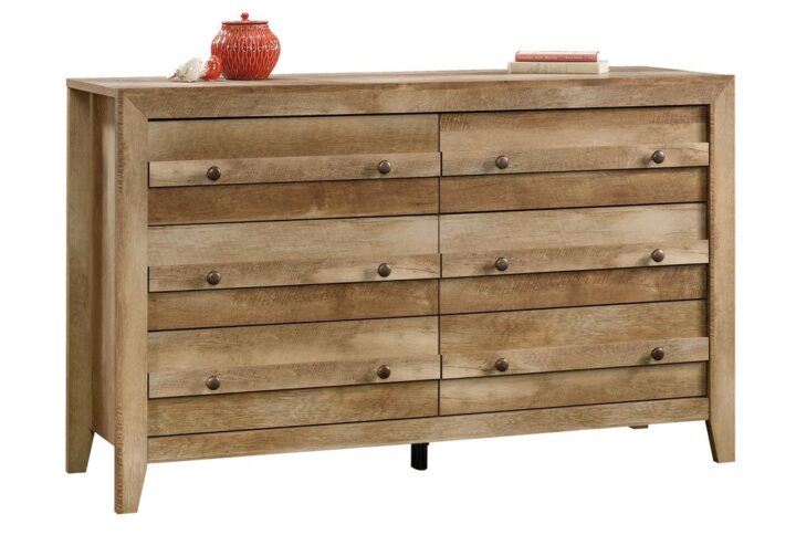 Achieve a rustic aesthetic in your bedroom with this 6-drawer dresser from the Dakota Pass® collection. It features six drawers that open and close on smooth metal runners with safety stops