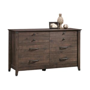 Rustic-inspired beauty and storage galore? Yes please! Give you bedroom a stylish update while adding versatile storage options for all your clothes and accessories with this dresser from the Carson Forge® collection. This handsome chest of drawers features six large drawers that open and close on smooth metal runners providing you with easy access storage for items like stacks of denim jeans and button up flannels to old sweatshirts and your secret stash of pajama pants. There is room for all your stuff! Its spacious top surface also provides ample room to store and display miscellaneous bedroom essentials and home décor items like an accent lamp