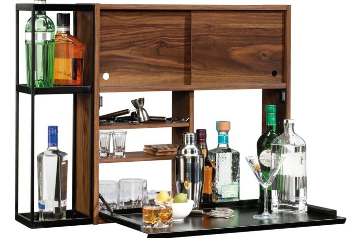 Limited space won't stop your home from being the life of the party. Impress your guests with the sophisticated style and innovative design of this wall bar from the Harvey Park collection. It features a flip-down bar top that creates a convenient mixing station which provides you with plenty of room to create your favorite cocktails. Behind the flip-down bar top is a hidden storage space for you to stow away your favorite beverages. It also includes two adjustable shelves for flexible storage options of items of all different shapes and sizes. Behind the sliding doors is an additional hidden storage area that is ideal for holding glasses