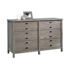 Is it time for a storage upgrade for your abundance of clothes and accessories? We've got just what you need! Increase the storage space in your bedroom while adding the beautiful style and design of this dresser from the Cottage Road® collection. It features six spacious drawers that open and close on smooth metal runners to create convenient storage options for your array of different items like your favorite button-up shirts and stacks of denim jeans to comfy sweatpants and cozy sweaters. It has a place for all your things! This rustic chest of drawers also features a spacious top surface that provides you with the perfect amount of space to store additional bedroom items and display some home décor like pictures of your family and friends