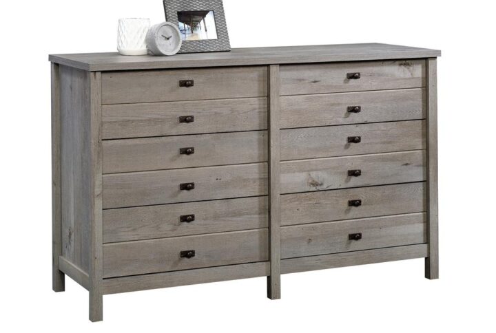 Is it time for a storage upgrade for your abundance of clothes and accessories? We've got just what you need! Increase the storage space in your bedroom while adding the beautiful style and design of this dresser from the Cottage Road® collection. It features six spacious drawers that open and close on smooth metal runners to create convenient storage options for your array of different items like your favorite button-up shirts and stacks of denim jeans to comfy sweatpants and cozy sweaters. It has a place for all your things! This rustic chest of drawers also features a spacious top surface that provides you with the perfect amount of space to store additional bedroom items and display some home décor like pictures of your family and friends