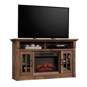 The center of attention in your living room deserves to stand out from the rest. Add a touch of rustic-inspired style and beauty to your home with this entertainment/fireplace credenza from the Sauder Select collection. This entertainment stand accommodates up to a 65" TV