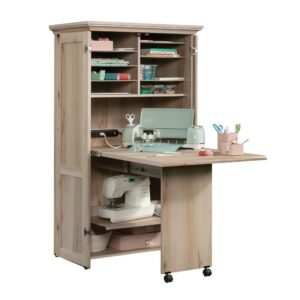 Add needed craft workspace to any room in your home with this multi-purpose armoire from the Sauder Select collection.  This craft armoire can function as a craft/sewing cabinet or as home office work surface depending on your home needs. A slide out shelf with full extension slides and a drop leaf extension creates an armoire with fold out table for a spacious work surface for your next craft project