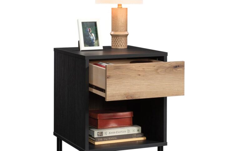 This nightstand with drawer from the Acadia Way® collection brings mixed aesthetics to any room in your home that you need an end table. This bedside table with storage features a drawer with metal runners and safety stops for ease of use storing your glasses