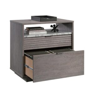 and it looks good while doing it. The spacious lower drawer holds letter or legal size hanging files to keep your most important documents organized and easy to access. The upper drawer of this legal size filing cabinet features a louvered front and gives another useful area for storing smaller items like office supplies or paper. Both drawers open and close on full extension metal slides. The open area of the lateral file cabinet with shelf adds a faux white marble accent plus additional storage for framed photos or other home décor. Use this shelf and the top surface to display what you wish. For added safety