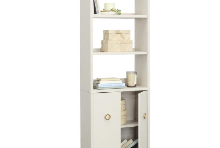 Display it or conceal it; stack it or store it; this bookcase with doors from the Grand Coast™ collection is a beachfront vacation from your typical storage options. Finished in gentle and glowing Dove Linen™