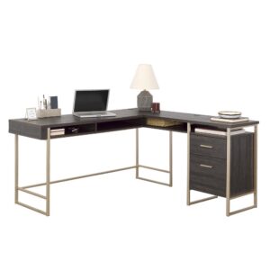 This modern L-shaped desk from the Walter Heights™ collection is a must-have for anyone looking to create a stylish and functional home office. The Blade Walnut™ finish paired with the powder-coated metal frame in an elegant champagne gold finish adds a touch of sophistication to this L-shaped desk. The spacious work surface of this home office desk provides ample room for multiple monitors