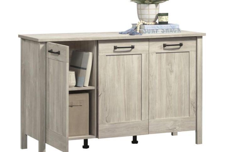 Boost your style while elevating your organization level with the Sauder Select 3-door storage cabinet. This sophisticated storage cabinet with doors seamlessly combines an elegant and classic aesthetic with ample storage solutions. Behind its three trendy