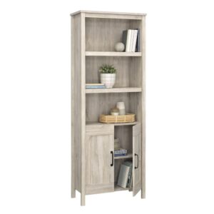 The 5-shelf bookcase from the Sauder Select collection is the perfect addition to any home seeking a touch of rustic charm. This versatile bookcase with doors combines functionality with a timeless design