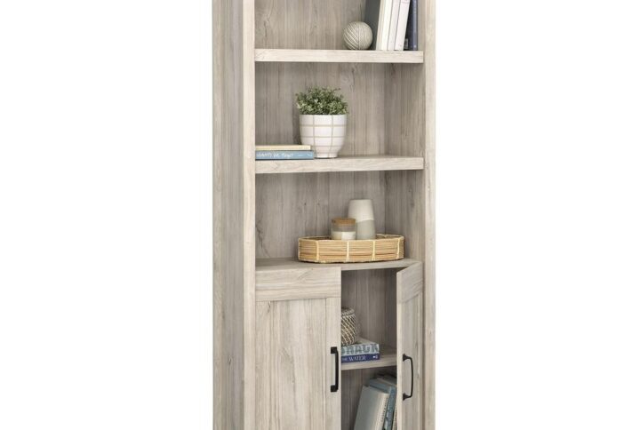 The 5-shelf bookcase from the Sauder Select collection is the perfect addition to any home seeking a touch of rustic charm. This versatile bookcase with doors combines functionality with a timeless design