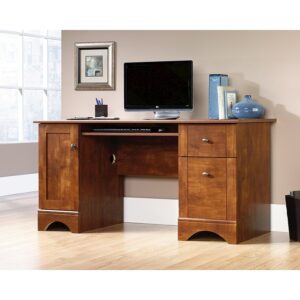 work in style with this maple-finish computer desk from the Sauder Select collection. A slide-out keyboard/mouse shelf with metal runners and safety stops keeps your top surface space free and helps with office ergonomics. This double pedestal desk includes two easy gliding drawers