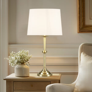 Add a touch of elegance to your living space with this beautiful Aelorian table lamp from the Bedford collection by Martha Stewart. This classic lamp features an antique brass finish and an empire fabric shade in off-white color. The on/off rotary switch is on socket and the lamp plugs in