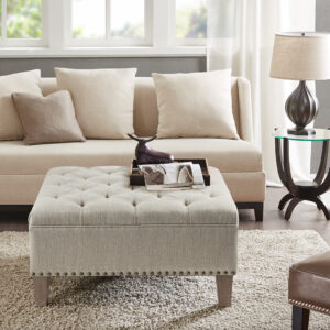 Complete your living space with the Madison Park Lindsey Tufted Square Cocktail Ottoman. This large square ottoman is upholstered fabric and features a button tufted top with piping details to create a chic traditional look. A nail head trim on bottom of the frame adds an elegant touch to the design