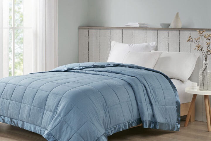 Make every night a cozy one with this textured oversized down alternative blanket. The color-matched 3" satin trim adds a luxury element that feels great on your skin. It features a 3M Scotchgard Moisture Management Treatment that wicks away moisture while helping release stains. Machine washable for easy care with a classic box quilting design. This hypoallergenic blanket is also OEKO-TEX certified