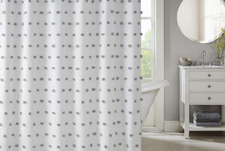 Add a fun update to your space with the Madison Park Sophie shower curtain. The solid white background features rows of soft grey fabric pom poms