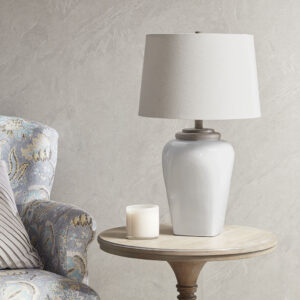 Illuminate your home with the charming style of the Martha Stewart Jemma Ceramic Table Lamp. Featuring a uniquely shaped white poly base and white tapered drum shade