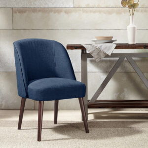 The soft curves of the wraparound back of this dining chair highlight the thin tapered legs