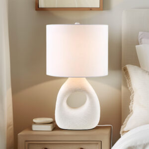 exuding casual elegance. Its white drum shade and matching finial radiate a warm glow