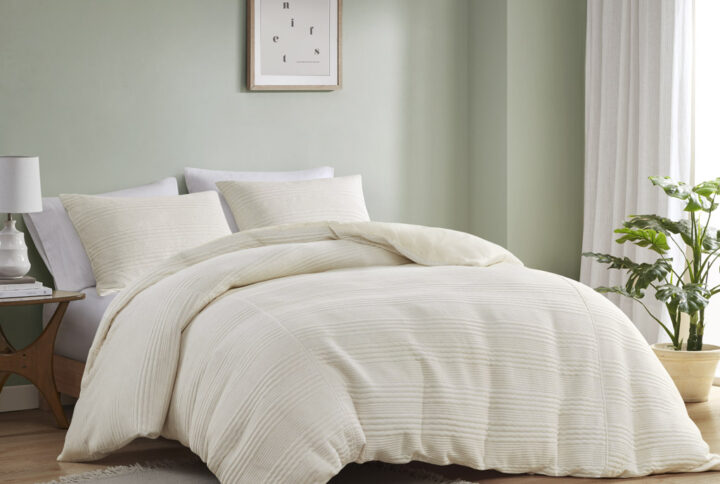 The Wyatt jersey duvet cover set features a unique knitted striped pattern in various widths for a modern look. Its soft texture and pieced heathered fabric add a casual and contemporary feel to your bedroom