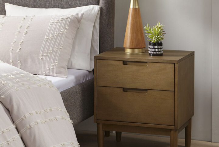 The INK+IVY Mallory Nightstand offers the perfect complement to your bedroom set. This rectangular nightstand features a rich walnut wood finish on the solid wood frame and legs