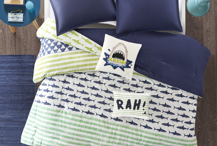 The Urban Habitat Kids Finn Comforter Set provides a fiercely fun update to your child’s bedroom. The 100% cotton comforter sports a shark and stripe print in navy and green colors that pops on the light grey background. A solid navy reverse adds a bold splash of color