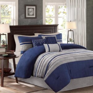 The Madison Park Palmer 7 Piece Comforter Set offers a classic and refined update to your bedroom decor. This transitional style comforter features a pieced microsuede design in rich contrasting blue and grey colors to create an incredibly soft look and feel. The 2 matching shams also flaunt a pieced construction to coordinate with the faux suede comforter. A solid grey bed skirt and 3 decorative pillows with a mix of embroidered designs add the perfect finishing touches to complete this lush traditionally-inspired comforter. Machine washable for easy care