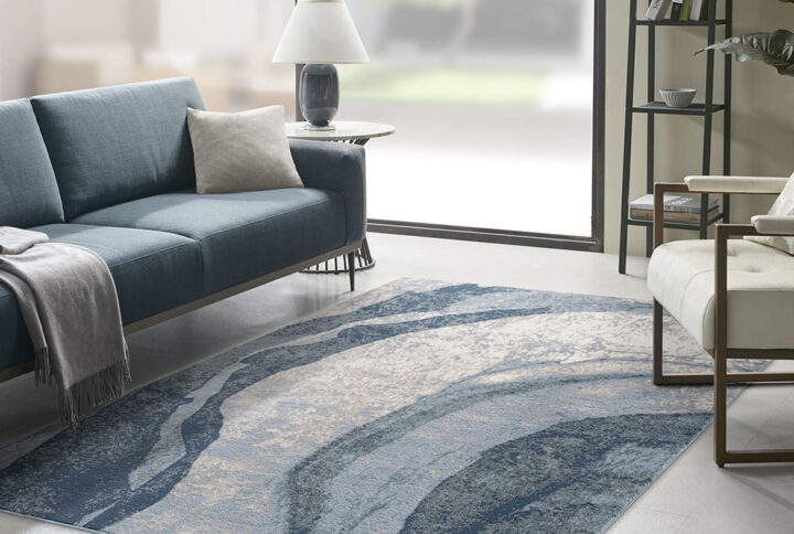 The Madison Park Grace Abstract Wave Area Rug offers a modern and artistic update to your home decor. This area rug features a soft