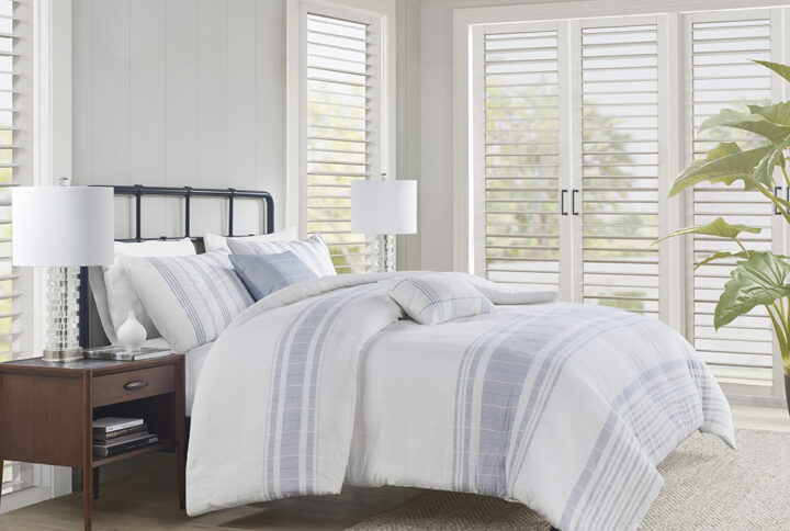 Introduce an upscale cottage charm to your bedroom with the Harbor House Morgan 5 Piece Cotton Duvet Cover Set. This 100% cotton jacquard duvet cover features textured vertical woven stripes with contrasting horizontal blue stripes on white ground