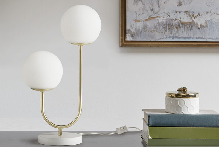 Brighten your bedroom or living room with the eye-catching elegance of this modern table lamp. This uniquely designed desk lamp features a curved stand