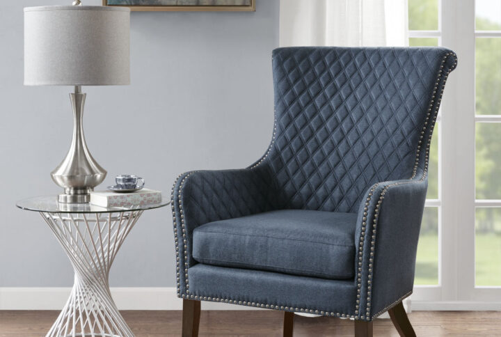 Relax in the luxurious style of the Madison Park Accent Chair. This modern accent chair takes on a classic twist with a quilted back and elegant silver studs lining the arms and seat. A high-density foam cushion fills the seat for exceptional comfort