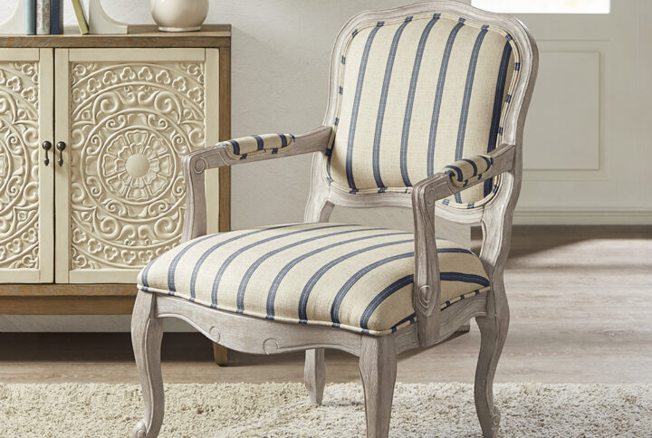 Update your living room decor with the Madison Park Monroe Accent Chair. This accent chair is upholstered in a natural-hued stripe pattern fabric and features pillow-topped arms for a sophisticated look. A reclaimed wood finish complements the upholstery